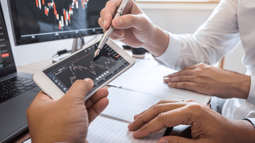 two person looking at forex trading chart in a mobile trading app