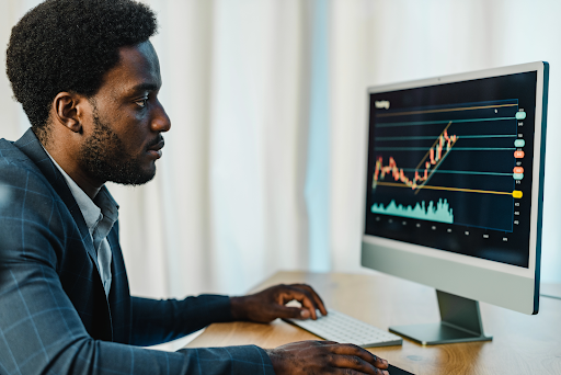 focused male broker using computer for trading